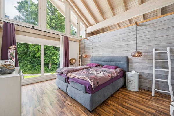 Stilvoller Schlafbereich mit raumhoher Fensterfront