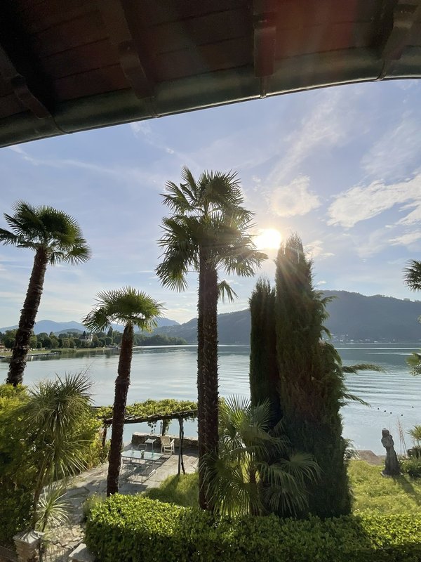 Blick aus dem Schlafzimmer auf  Palmen und Wasser