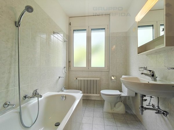 / a white bathroom with a tub, sink, toilet and shower