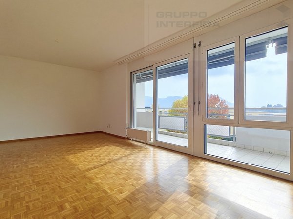 / an empty room with wooden floors, large windows and sliding doors